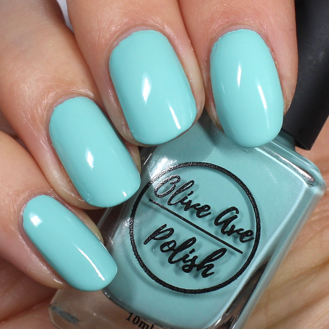Tiffany blue nail polish on pale skin tone 