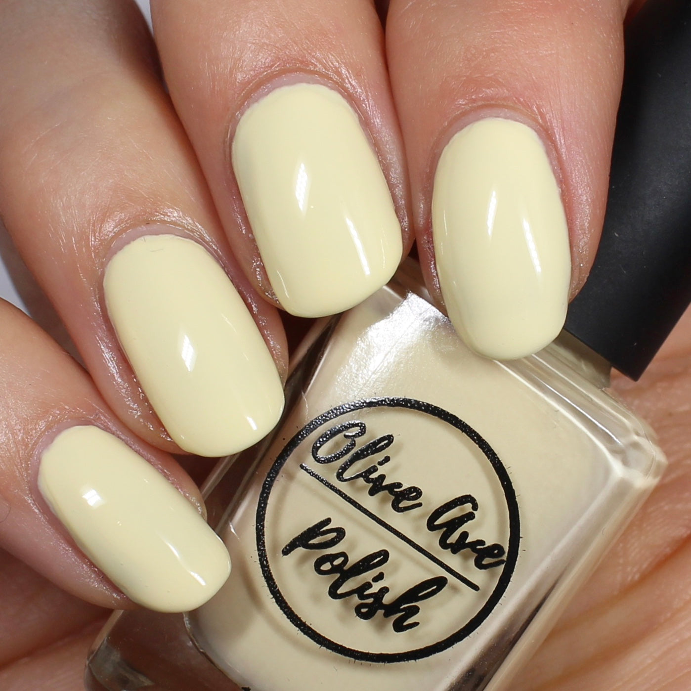 Pastel yellow nail polish swatch on pale skin tone