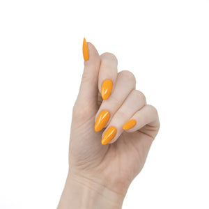 bright orange nail polish swatch on pale skin tone