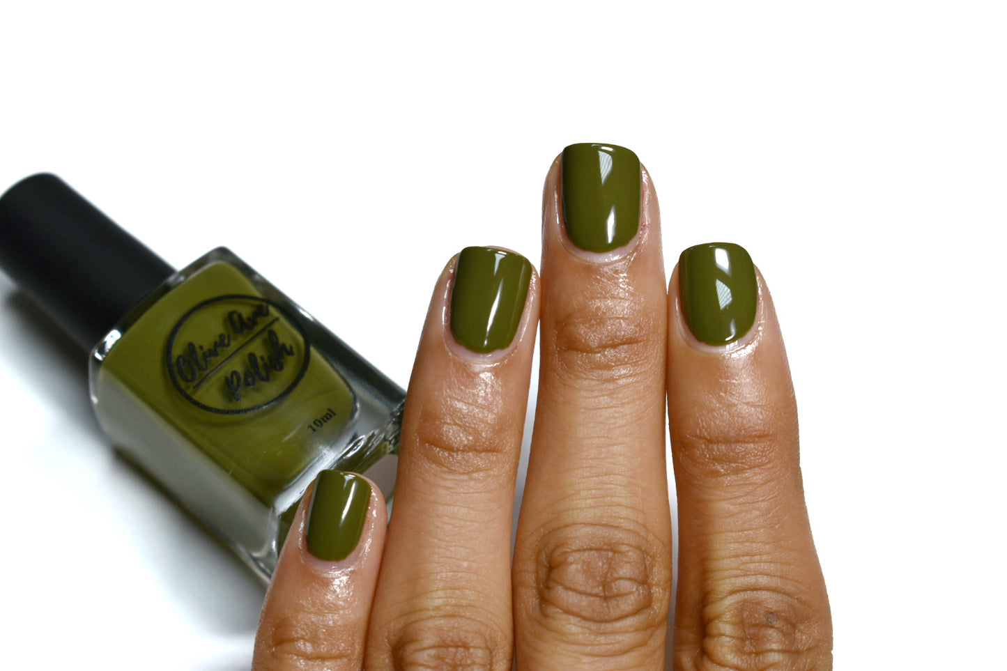 olive green nail polish swatch on medium skin tone