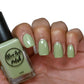sage green nail polish swatch on medium skin tone