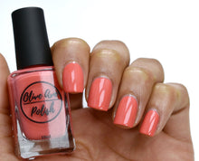Load image into Gallery viewer, Bright coral nail polish swatch on medium skin tone