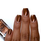 metallic brown nail polish swatch on medium skin tone