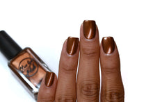 Load image into Gallery viewer, metallic brown nail polish swatch on medium skin tone