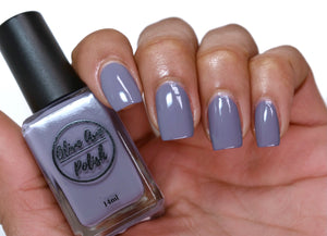 purple grey nail polish swatch on medium skin tone