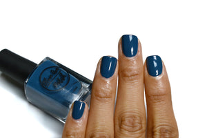 Peacock blue nail polish swatch on medium skin tone