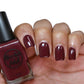 Burgundy wine nail polish swatch on pale skin tone
