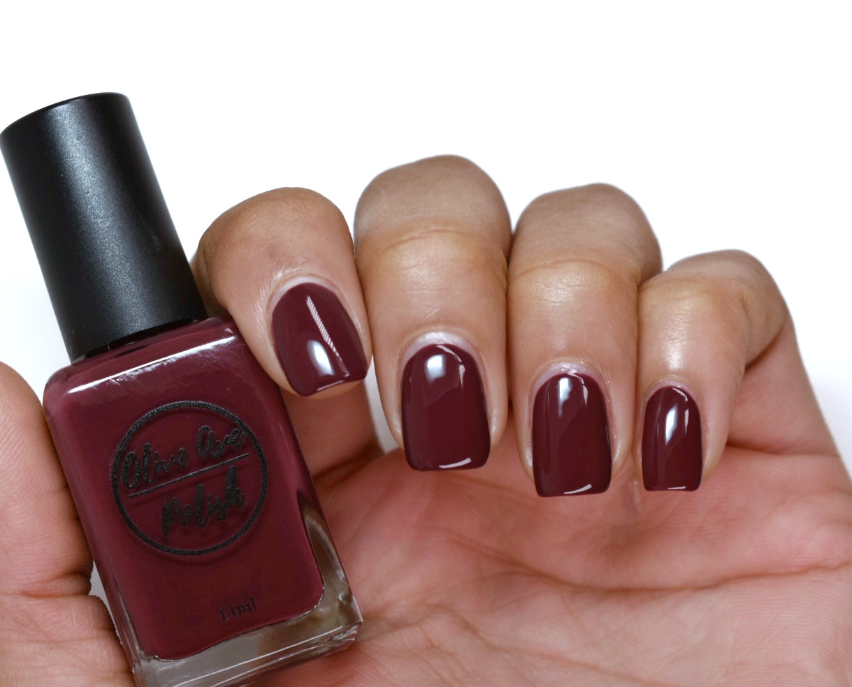 Burgundy wine nail polish swatch on pale skin tone