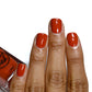fall red nail polish swatch on medium skin tone