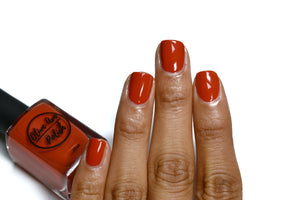 fall red nail polish swatch on medium skin tone