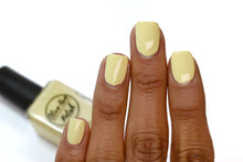 Load image into Gallery viewer, pastel yellow nail polish swatch on medium skin tone