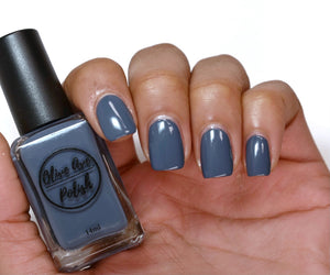 blue grey nail polish swatch on medium skin tone