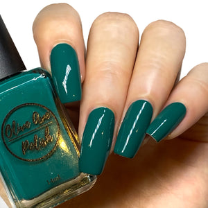 Emerald green nail polish swatch on pale skin tone