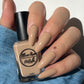 Tan nude nail polish swatch on pale skin tone