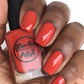 fall red nail polish swatch on medium dark skin tone