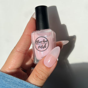 sheer pink nail polish swatch on pale skin tone