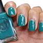 Emerald green nail polish swatch on pale skin tone